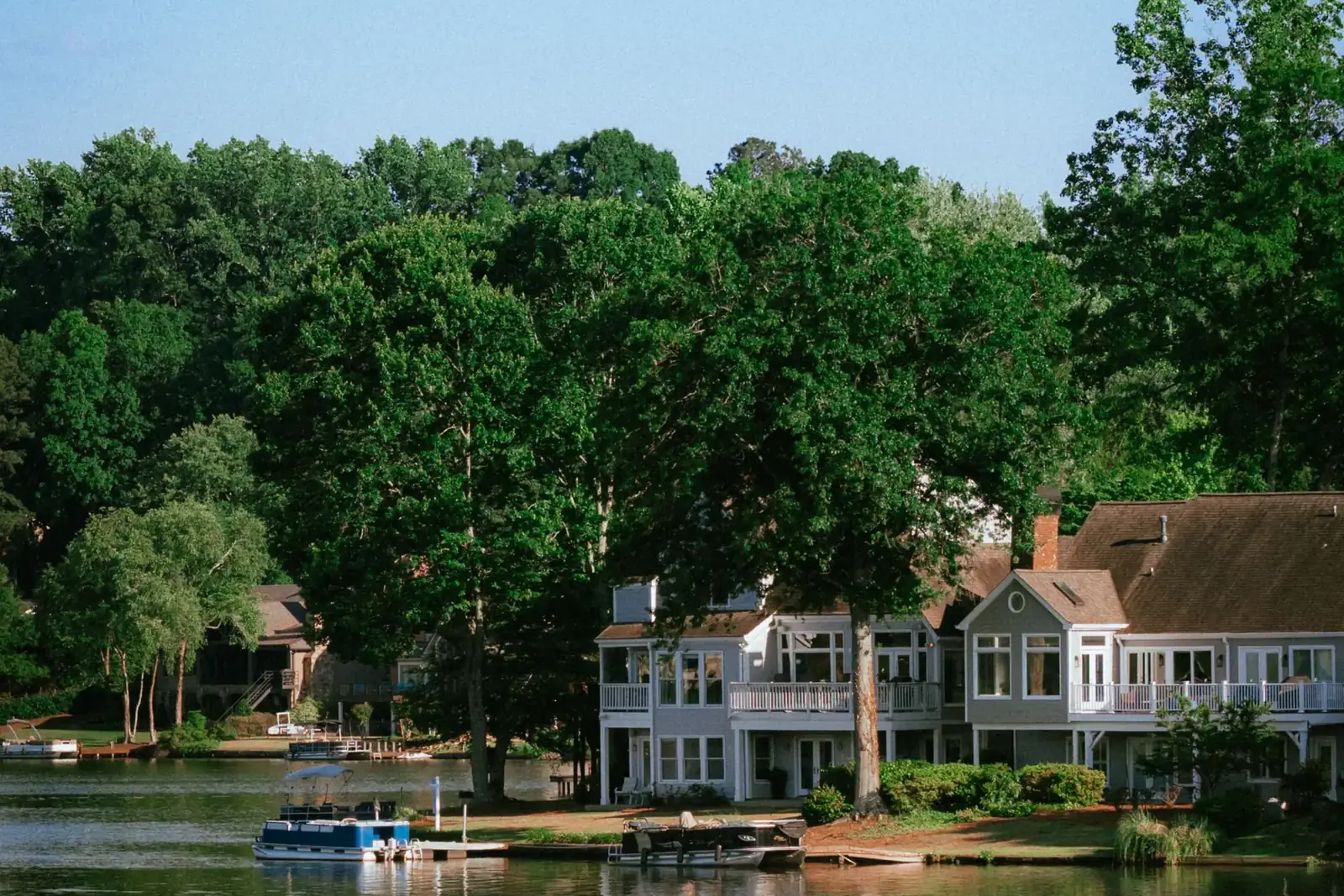 Homes among trees beside a lake